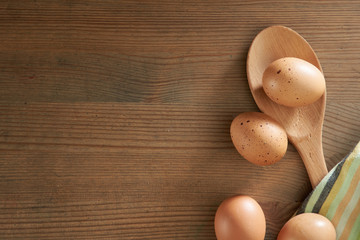 brown egg laying on a wooden cutting board