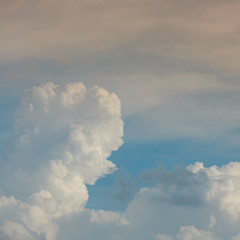 fluffy white cloud above clear blue sky background