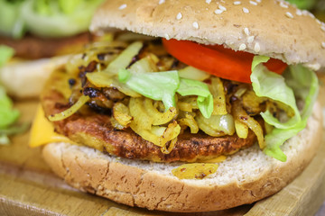 burger au poulet, oignons, salade et tomate