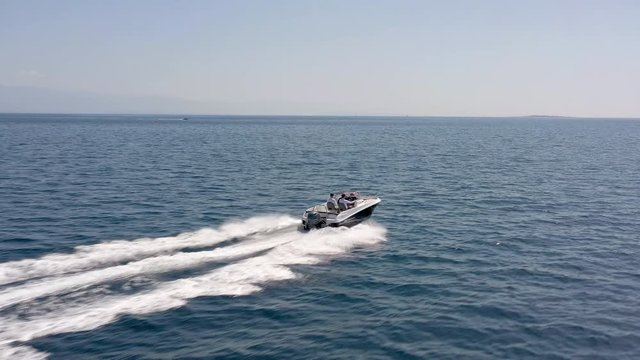 Aerial - Side view tracking shot of group of friends enjoying the ride on privat