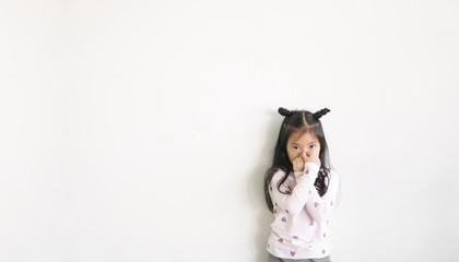 Asian child or kid girl hand covered or close nose to smelly or sneezing and cold sick to weak from covid 19 virus and bacteria or dust with allergy on preschool for medical background and white space