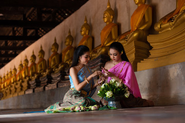 A girl wearing Thai clothes sitting