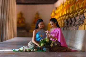 A girl wearing Thai clothes sitting