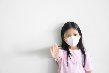 Asian child or kid girl wear N95 paper face mask 3D for close mouth nose and sick with cold cough...