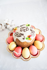 Easter cake on a plate with colored eggs