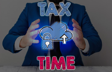 Conceptual hand writing showing Tax Time. Concept meaning compulsory contribution state revenue...