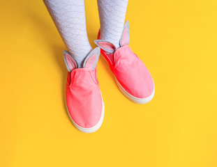Decorate pink sneakers diy. Easter holiday rabbit.Children's feet.