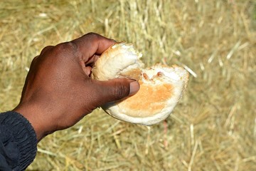 African black hand with bread piece