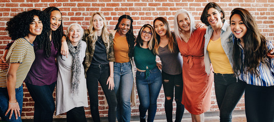 Happy diverse women in a row