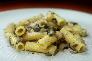 A dish of rigatoni with red radicchio sauce