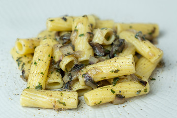 A dish of rigatoni with red radicchio sauce