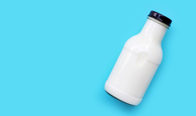 Milk bottle on blue background.