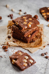 brownie cake wit hazelnut and chocolate on concrete table