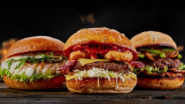 Various tasty Burger with fish and beef on fire and flames  backgroudn for restaurant advertising