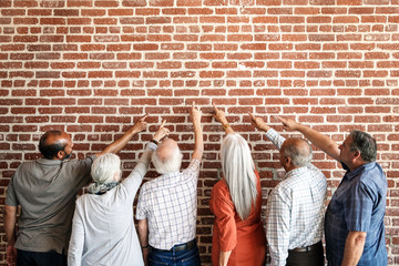 Old people facing the brick wall