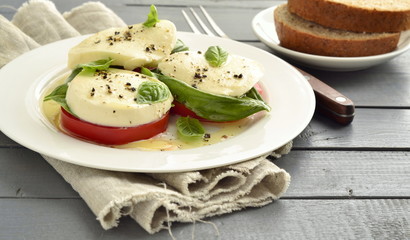 Caprese salad of tomato, mozzarella, basil. Italian food, copy space