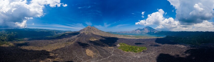 Aerial view of solidified black volcanic lava flows around the slopes of an active volcano.  (Mount Batur)