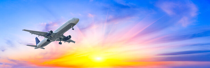 Commercial airplane flying in beautiful sky at sunset,travel concept.