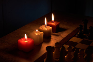 Chess game in the light of four square candles