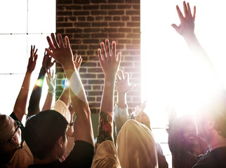 Group of people with their hands raised