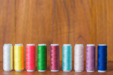 Colorful yarn on spool, yarn on tube, cotton, wool, linen thread,Color sewing threads on white background, top view