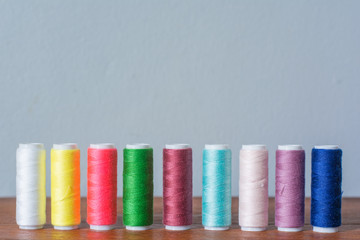 Colorful yarn on spool, yarn on tube, cotton, wool, linen thread,Color sewing threads on white background, top view