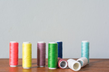 Colorful yarn on spool, yarn on tube, cotton, wool, linen thread,Color sewing threads on white background, top view