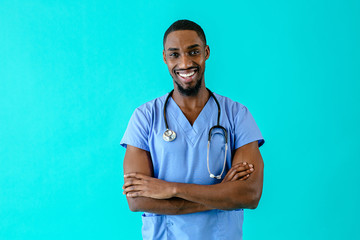 Portrait of a friendly male doctor or nurse wearing blue scrubs uniform and stethoscope, laughing...