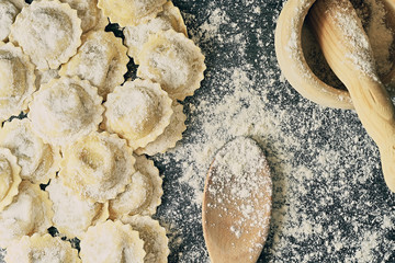 Tasty raw italian floured ravioli on wooden.