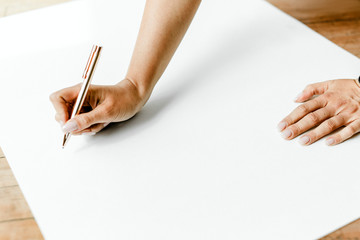 Businesswoman writing on a paper