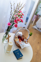 Festive Easter table setting with basket at traditional meals. Easter breakfast in Poland. Christian tradition commemorating the resurrection of Jesus. Holy Bible.