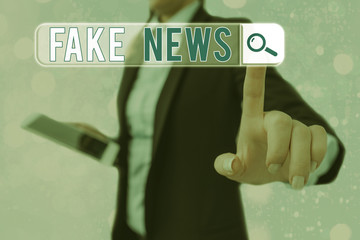 Conceptual hand writing showing Fake News. Concept meaning false information publish under the...
