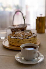 Festive cheesecake on the table with a cup of coffee. Easter time.
