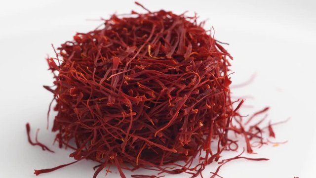 Heap of saffron threads, autumn crocus, on turntable isolated on white background