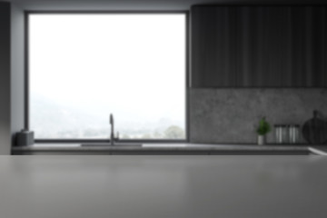Table in blurry gray kitchen with sink and window
