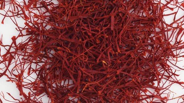 Saffron threads close up rotation top view. Food background. Gastronomy concept, organic food. Macro dried flowers and leaves saffron