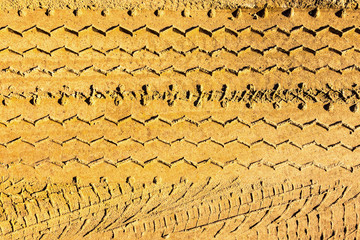 Car footprints  in the sand