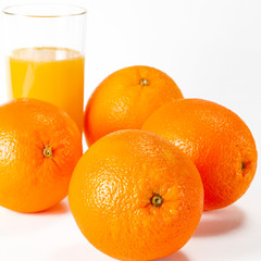 glass of fresh orange juice with fresh fruits on white background