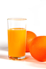 glass of fresh orange juice with fresh fruits on white background