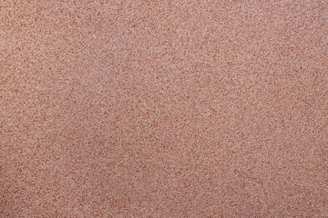 Fototapeta premium Against the background of disseminated sand small gravel, a stone crumb. Texture of a surface of a wall,light color