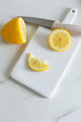 sliced lemon on a white ceramic board