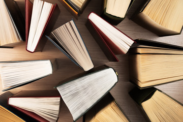 Naklejka premium Books top view. They stand ajar on the table, the sheets spread out like a fan. Back to school. Education. Reading.