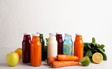 Detox set with different flavoured smoothie drinks in glass bottles
