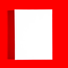 Mockup of closed blank square book at white textured paper