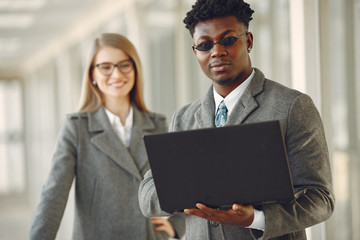 Handsome man in a black suit. Businessman working in a office. Woman with her partner.