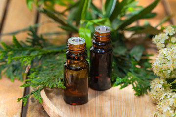 Assortment of natural oils in glass bottles on wooden background. Concept of pure organic ingredients in cosmetology. Bath accessoiries, atmosphere of harmony, relax. Close up macro. Healthy lifestyle