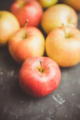 Close-up apples on the rustic wooden background. Selective focus. Shallow depth of field.

