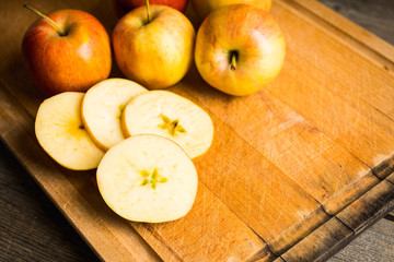 Close-up apples on the rustic wooden background. Selective focus. Shallow depth of field.
