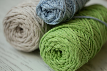 Fototapeta na wymiar Skeins of natural cotton threads in green, blue and gray colors