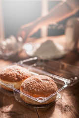 Delicious donuts in a plastic container